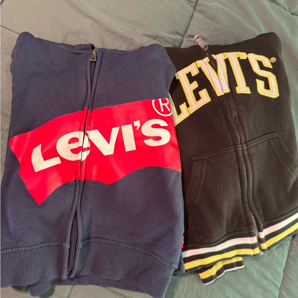 Pair of Levi’s hoodies with zippers.